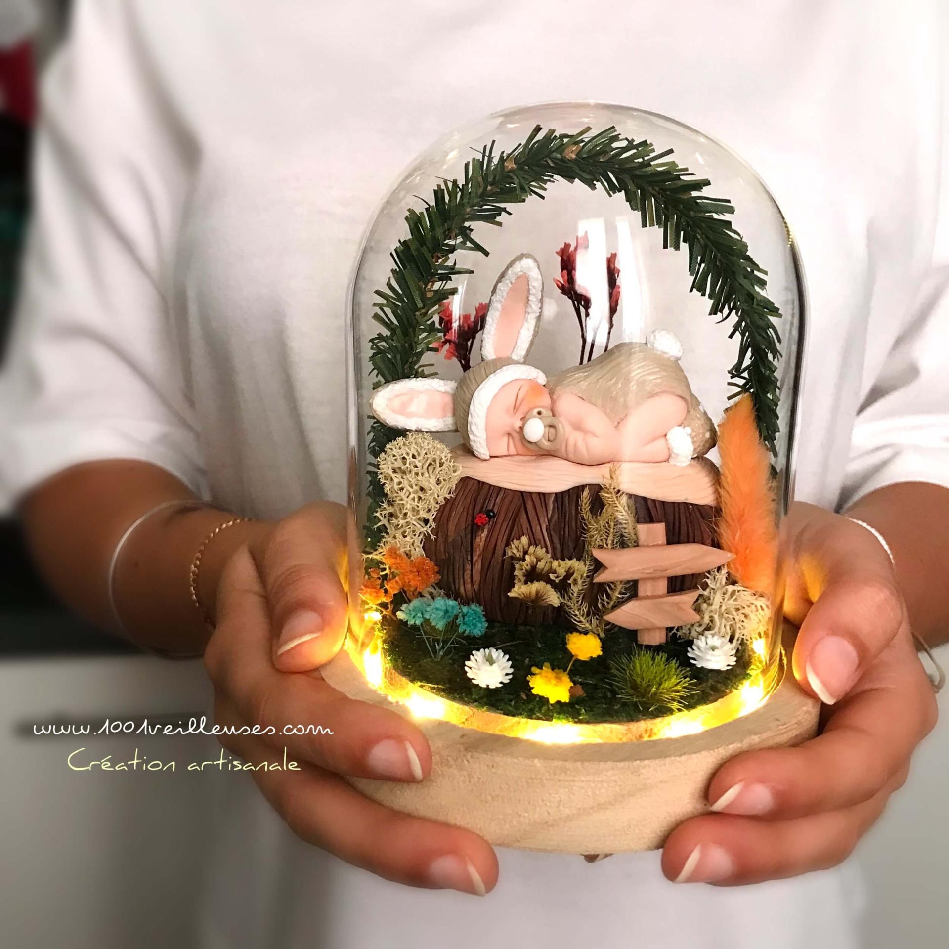 Personalized and handmade eternal bell-shaped night light, featuring an adorable baby dressed as a gray rabbit, presented in hands