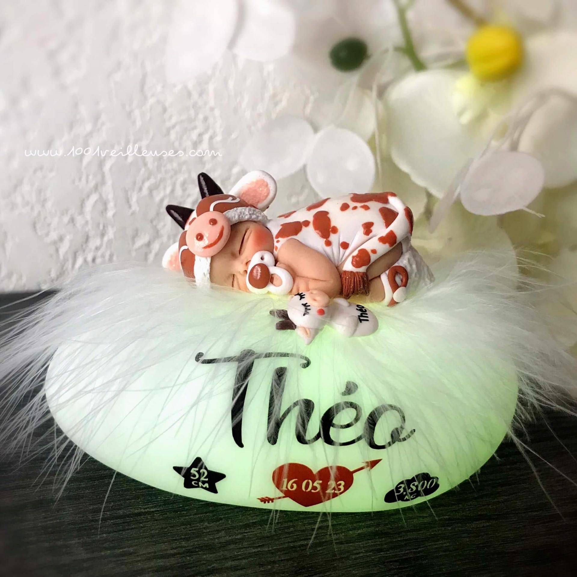Illuminated night light with a handmade baby dressed in cow colors, personalized with the name