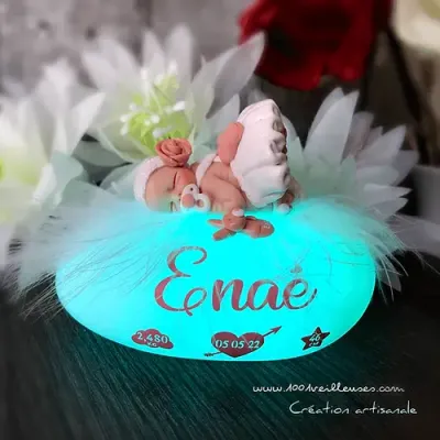 Personalized LED pebble-shaped nightlight with a hand-sculpted little girl, customized miniature elements, front view
