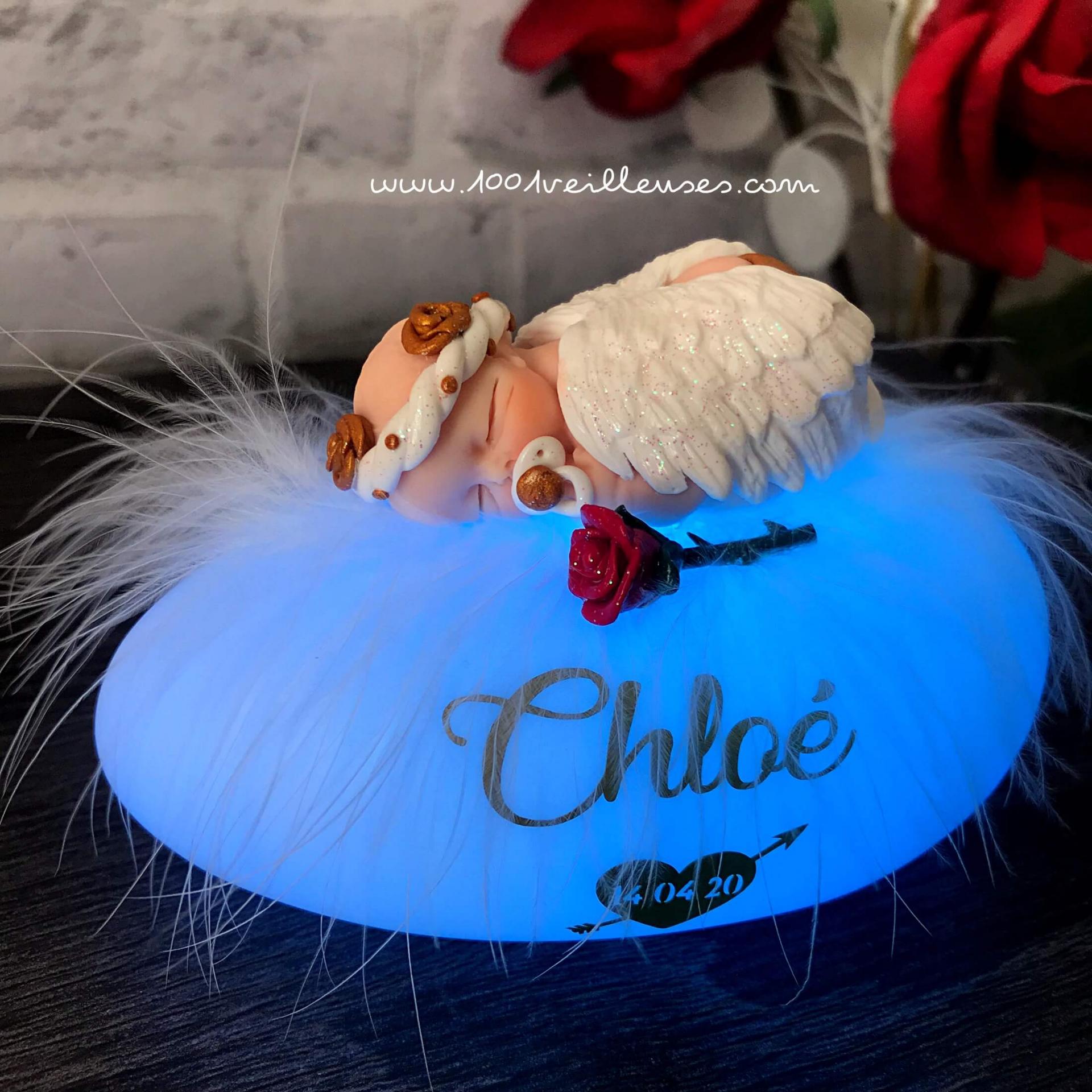 Personalized children's night light, hand-carved luminous pebble in polymer clay. Name, weight, date, and birth size engraved, lamp lit, angled view
