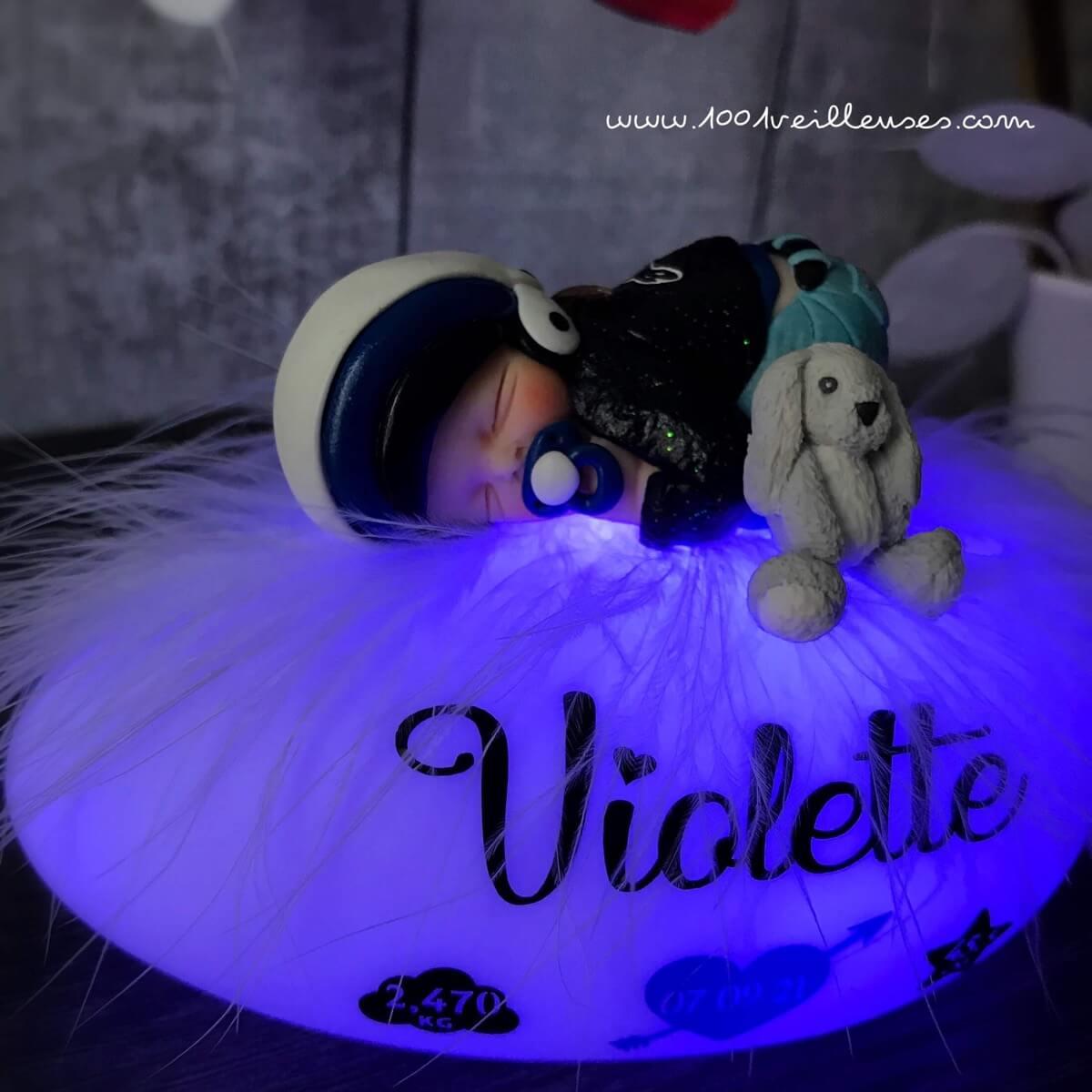 Personalized nightlight with miniature biker baby and cuddly toy, close-up view